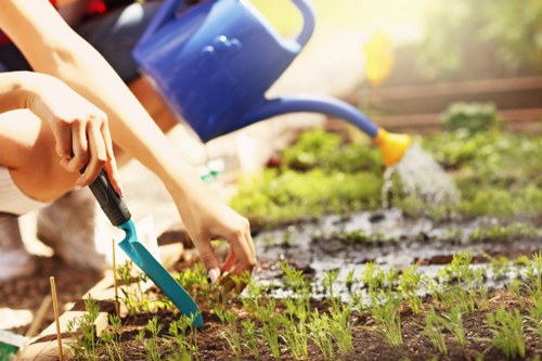 Front view of a gardener arriving at a landscaped urban garden